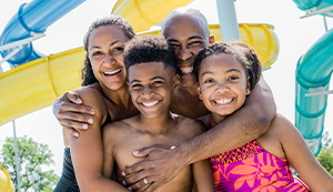 a family embracing at a water park